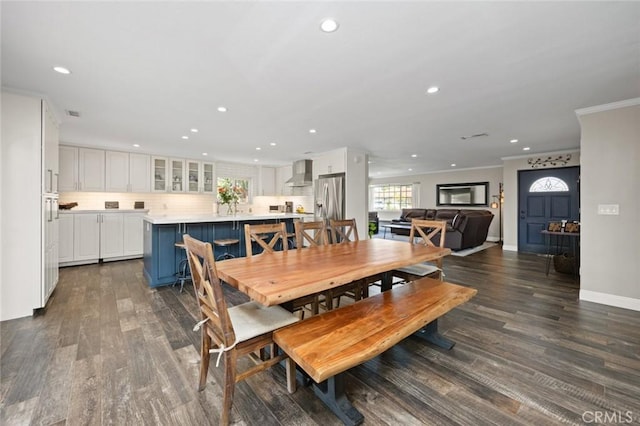 dining room with crown molding, recessed lighting, baseboards, and dark wood finished floors