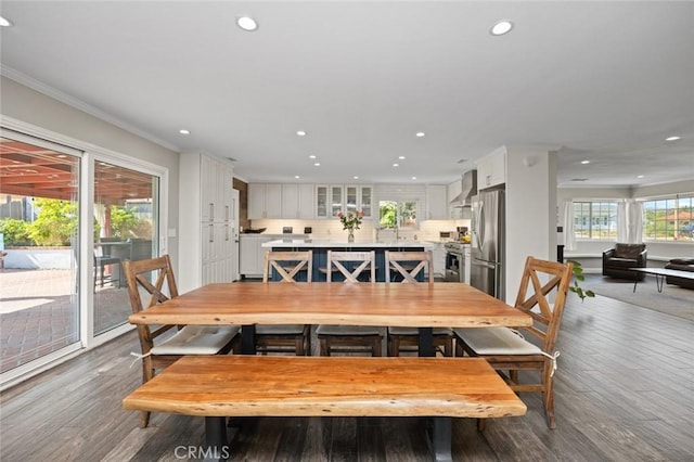 dining area featuring crown molding, recessed lighting, and wood finished floors