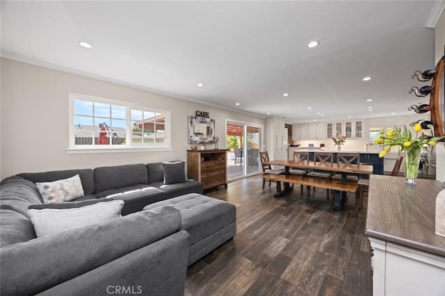 living room with crown molding, recessed lighting, and dark wood-style flooring