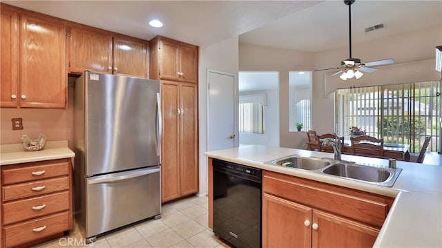 kitchen with visible vents, freestanding refrigerator, light tile patterned flooring, a sink, and dishwasher