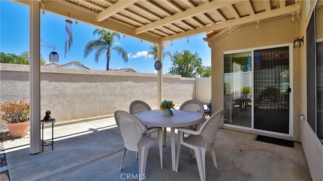 view of patio / terrace featuring fence and outdoor dining area