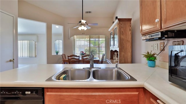 kitchen with brown cabinets, a sink, light countertops, black dishwasher, and visible vents