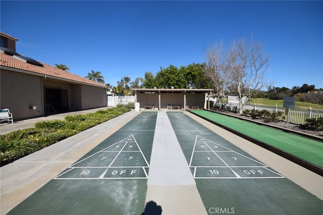 surrounding community featuring fence and shuffleboard