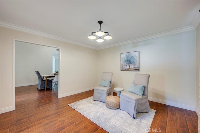 living area featuring crown molding, baseboards, and hardwood / wood-style flooring