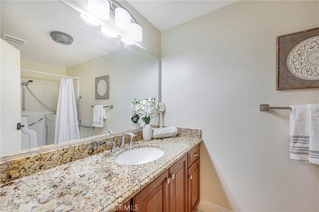 bathroom with visible vents, a shower with shower curtain, and vanity