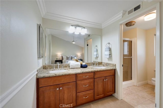 ensuite bathroom featuring visible vents, a sink, ceiling fan, and a shower stall