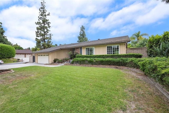 single story home featuring fence, an attached garage, concrete driveway, and a front yard