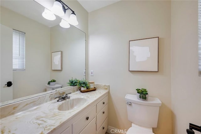 half bathroom with toilet and vanity