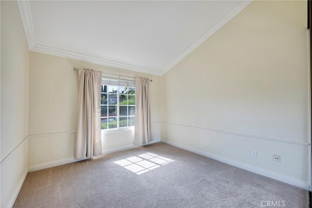 carpeted spare room with baseboards, ornamental molding, and vaulted ceiling