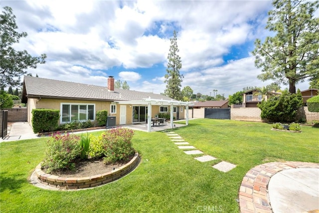 back of property featuring a chimney, a lawn, fence, cooling unit, and a patio