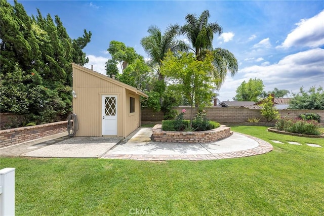 view of yard featuring a fenced backyard, an outdoor structure, and a patio area