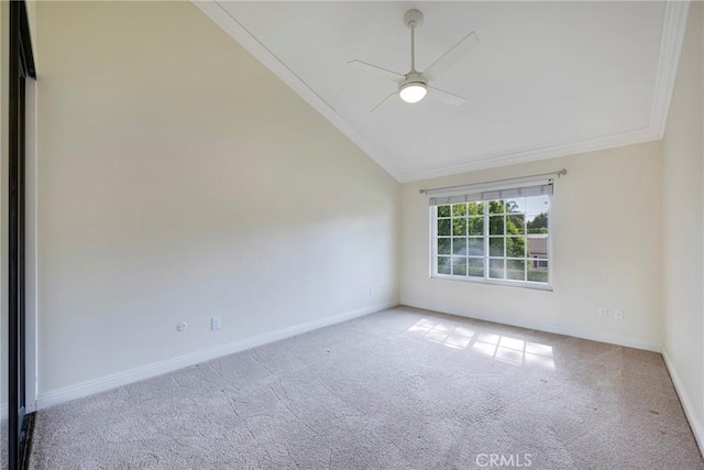 empty room with crown molding, ceiling fan, carpet, baseboards, and vaulted ceiling