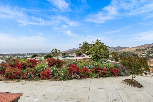 exterior space featuring a mountain view and a patio area