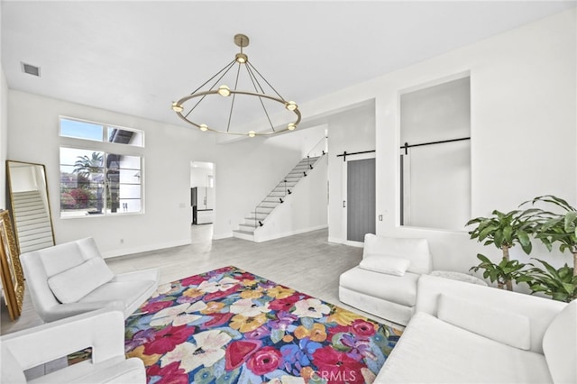 living room featuring stairway, baseboards, visible vents, and a chandelier