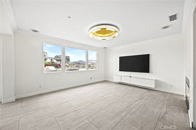 unfurnished living room featuring baseboards, ornamental molding, and visible vents