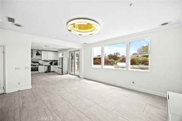 unfurnished living room featuring baseboards, ornamental molding, and visible vents