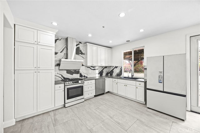kitchen featuring a sink, dark countertops, wall chimney range hood, and stainless steel appliances