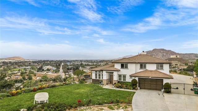 view of front of house featuring a gate, a mountain view, stucco siding, and concrete driveway