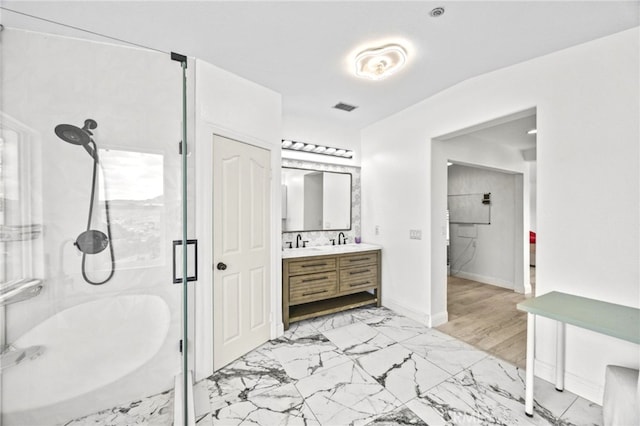 full bathroom featuring visible vents, vanity, marble finish floor, baseboards, and a shower stall