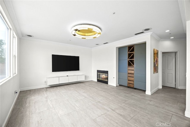 unfurnished living room with crown molding, baseboards, and plenty of natural light