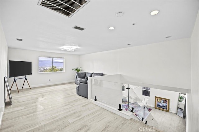 interior space with baseboards, visible vents, and wood finished floors