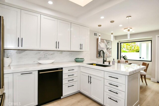 kitchen with white cabinets, a sink, dishwasher, a peninsula, and recessed lighting
