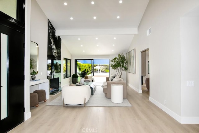living room with recessed lighting, baseboards, lofted ceiling with beams, and light wood-style floors