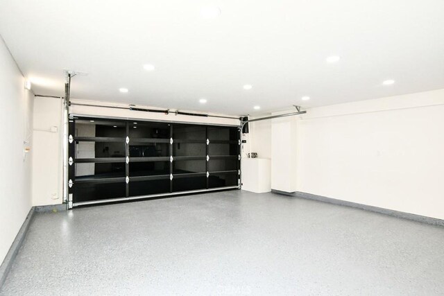 garage with baseboards and recessed lighting