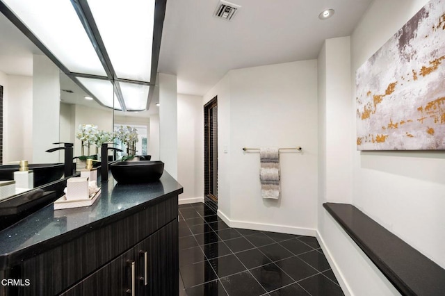 full bath featuring visible vents, a sink, baseboards, and tile patterned floors