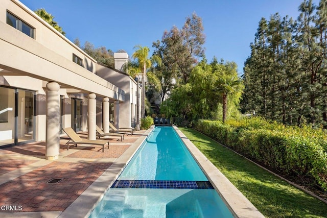 view of pool with a patio and a pool with connected hot tub