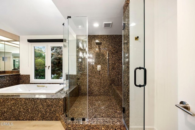 full bath featuring a garden tub, a stall shower, and visible vents