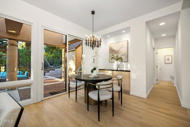 dining room featuring recessed lighting, baseboards, a chandelier, and light wood-style flooring