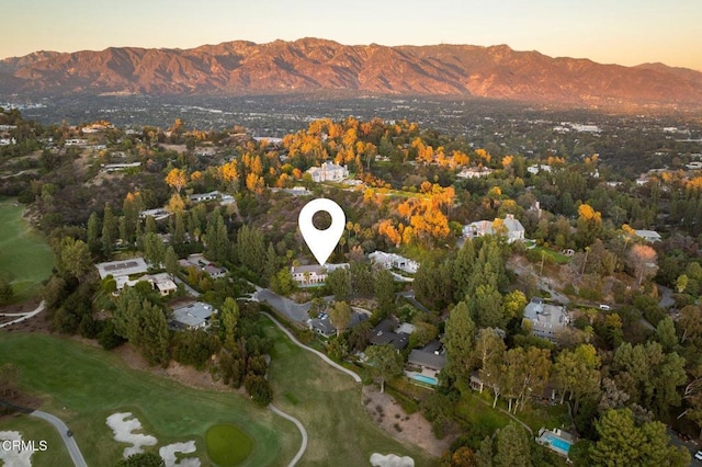 bird's eye view with view of golf course and a mountain view
