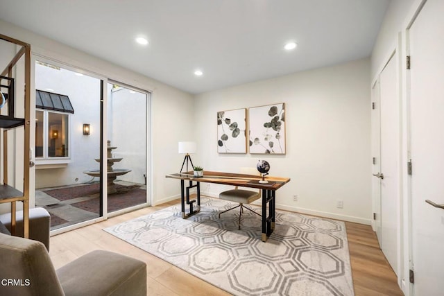 office area with recessed lighting, baseboards, and light wood finished floors