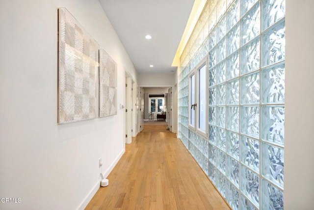 corridor with recessed lighting, baseboards, and light wood-style floors