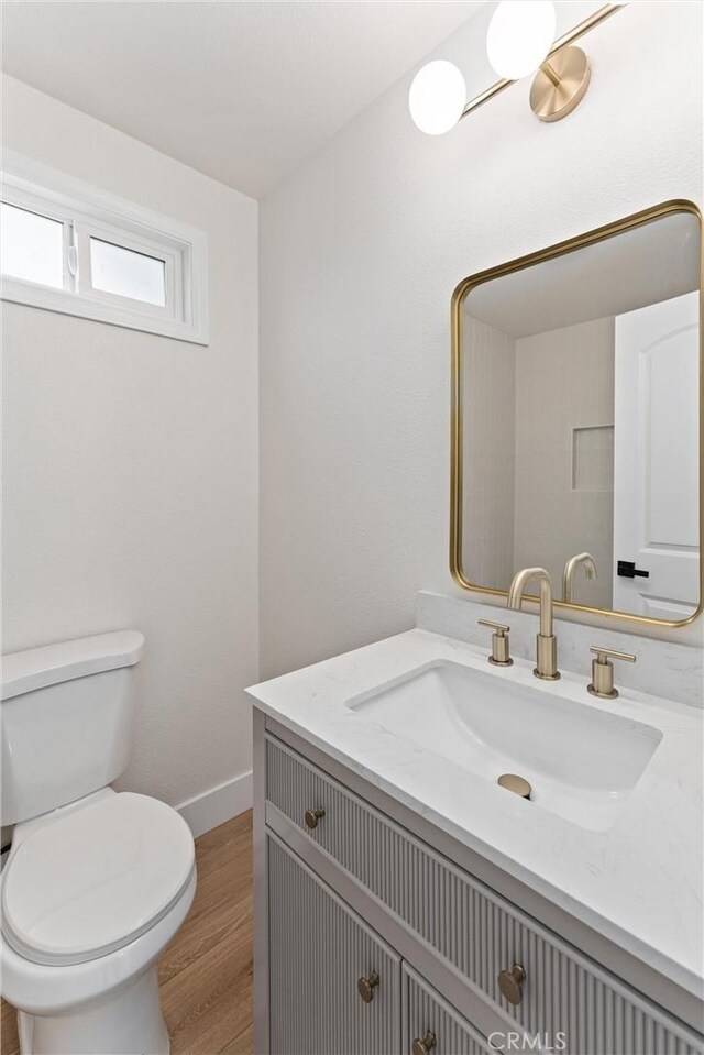 920 W Hollyvale St, Azusa, CA 91702 - bathroom with vanity, toilet, wood finished floors, and baseboards