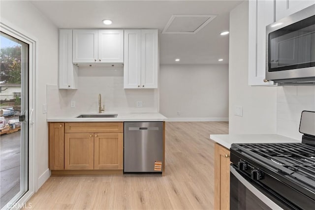 920 W Hollyvale St, Azusa, CA 91702 - kitchen with stainless steel appliances, a sink, light wood-style floors, light countertops, and recessed lighting