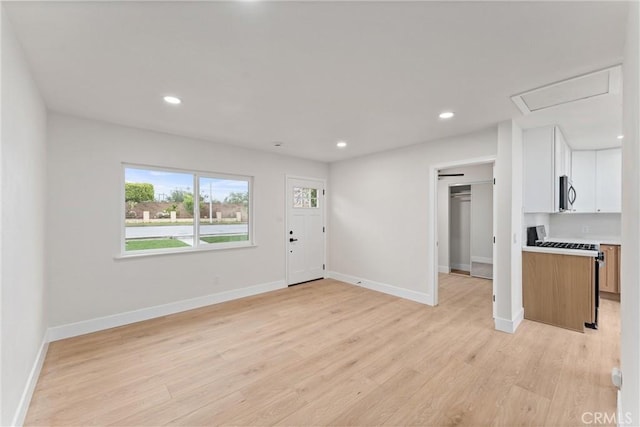 920 W Hollyvale St, Azusa, CA 91702 - unfurnished living room featuring light wood finished floors, baseboards, recessed lighting, and attic access