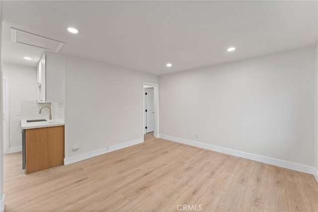 920 W Hollyvale St, Azusa, CA 91702 - empty room featuring a sink, light wood-style flooring, baseboards, attic access, and recessed lighting