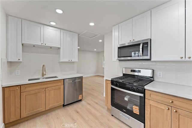 920 W Hollyvale St, Azusa, CA 91702 - kitchen featuring stainless steel appliances, a sink, light wood-style floors, decorative backsplash, and recessed lighting