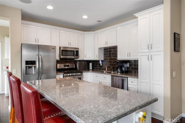 4 Mosaic, Aliso Viejo, CA 92656 - kitchen featuring white cabinets, baseboards, and appliances with stainless steel finishes