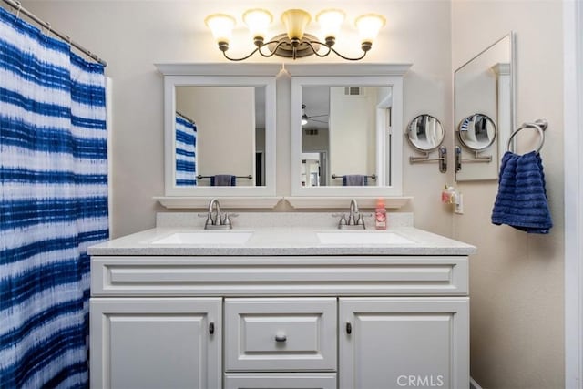4 Mosaic, Aliso Viejo, CA 92656 - bathroom featuring double vanity, a sink, and ceiling fan with notable chandelier