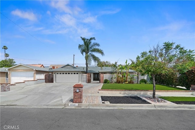 single story home featuring fence, an attached garage, driveway, and a front lawn