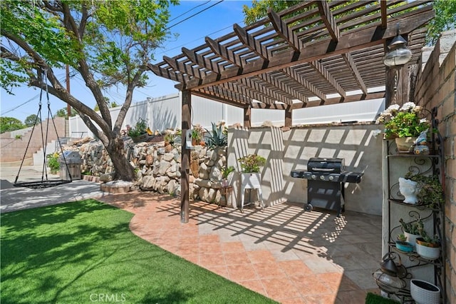 view of patio with area for grilling, a pergola, and fence