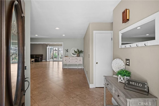entryway with baseboards, tile patterned flooring, and recessed lighting