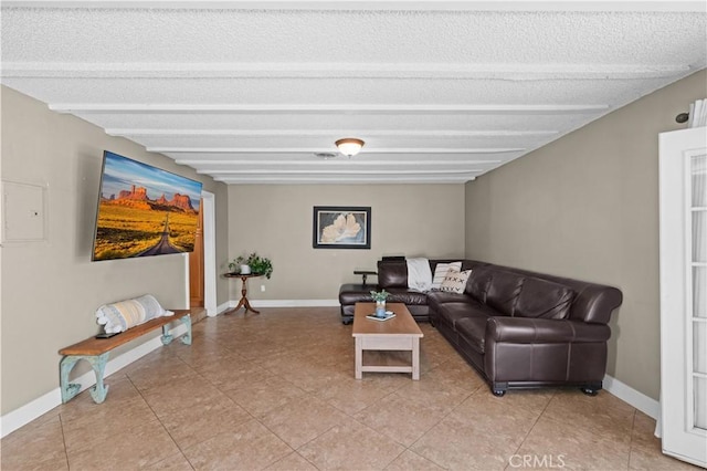 living area with a textured ceiling, baseboards, and light tile patterned floors