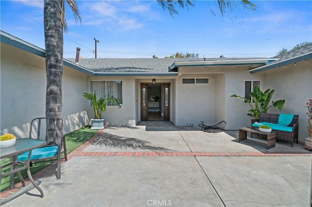 8784 Lurline St, Rancho Cucamonga, CA 91701 - entrance to property featuring stucco siding, roof with shingles, and a patio