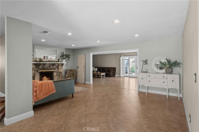 8784 Lurline St, Rancho Cucamonga, CA 91701 - living area with baseboards, a stone fireplace, recessed lighting, and tile patterned flooring