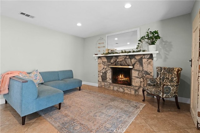 tiled living room with visible vents, recessed lighting, baseboards, and a fireplace