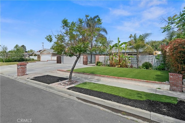 single story home with a garage, concrete driveway, and a front yard